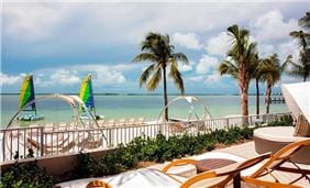 Playa Largo beach with hammocks and sailboats.